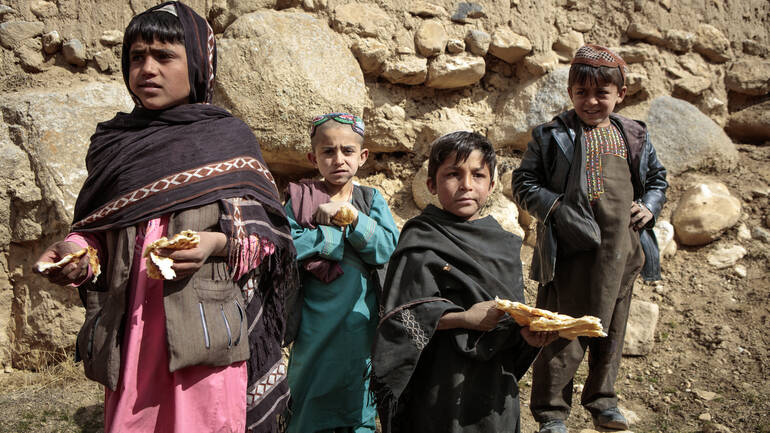 Kinder in Afghanistan essen Brot