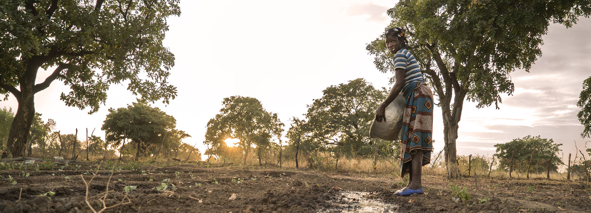 Eine Frau beim Gießen in einem Gartenprojekt in Burkina Faso