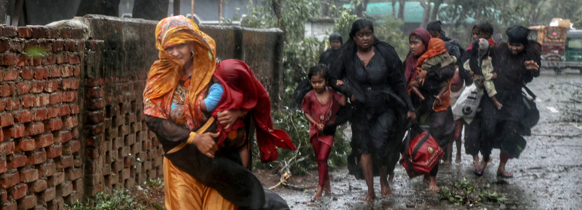 Frauen mit Kindern flüchten durch den Regen vor Zyklon Mocha in Bangladesch