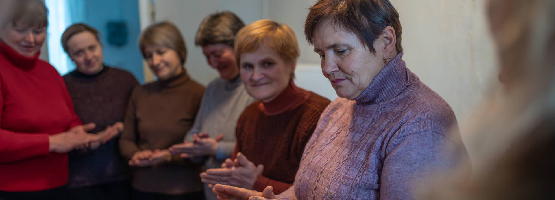 Stehende Frauengruppe bei einer psychologischen Gruppensitzung von Aktion gegen den Hunger in der Klinik von Kurmany, Region Sumy Stehende Frauengruppe bei einer psychologischen Gruppensitzung von Aktion gegen den Hunger in der Klinik von Kurmany, Region Sumy