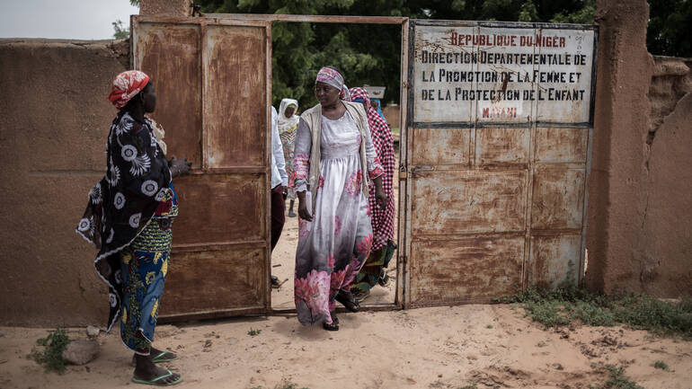 Frau tritt aus einem Tor im Niger.