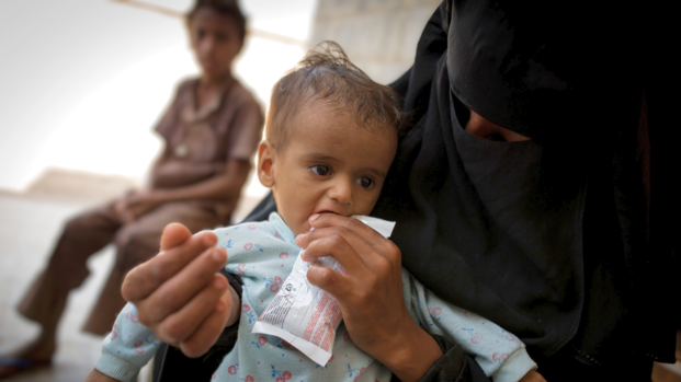Mitarbeiterin von Aktion gegen den Hunger behandelt Kind im Jemen gegen Mangelernährung